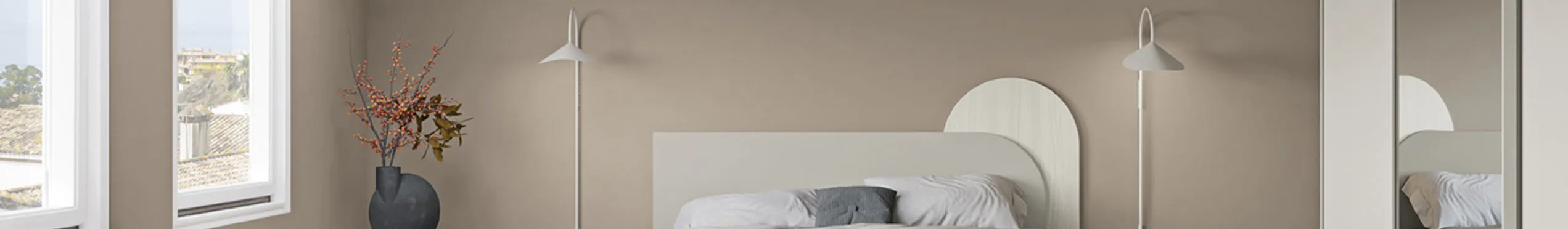 Una camera da letto matrimoniale con armadio specchio